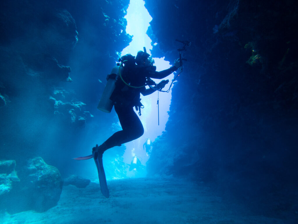 Fran silhouetted in one of the sea valleys - Niue